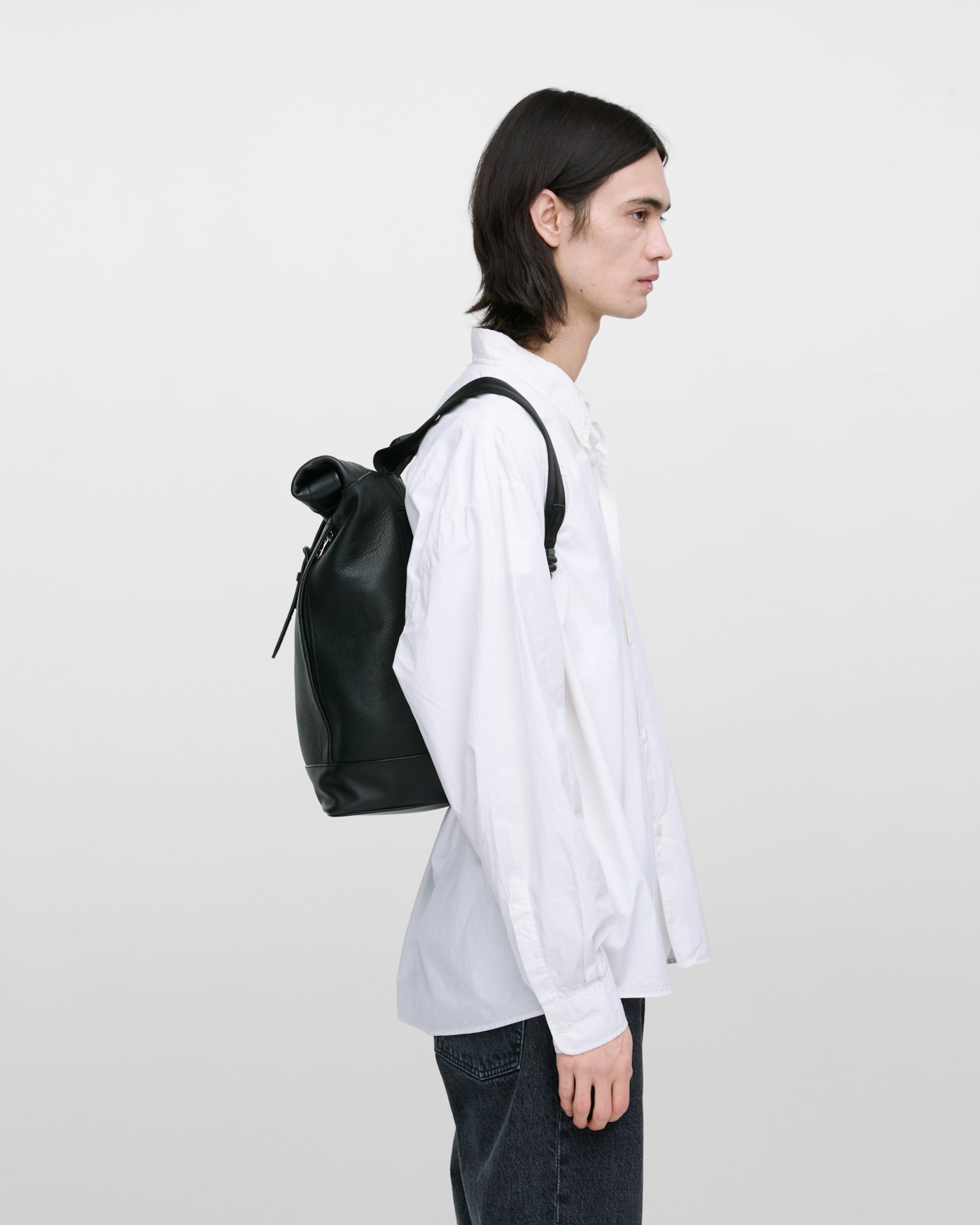 Leather rolltop backpack is in color black (11 of 15)