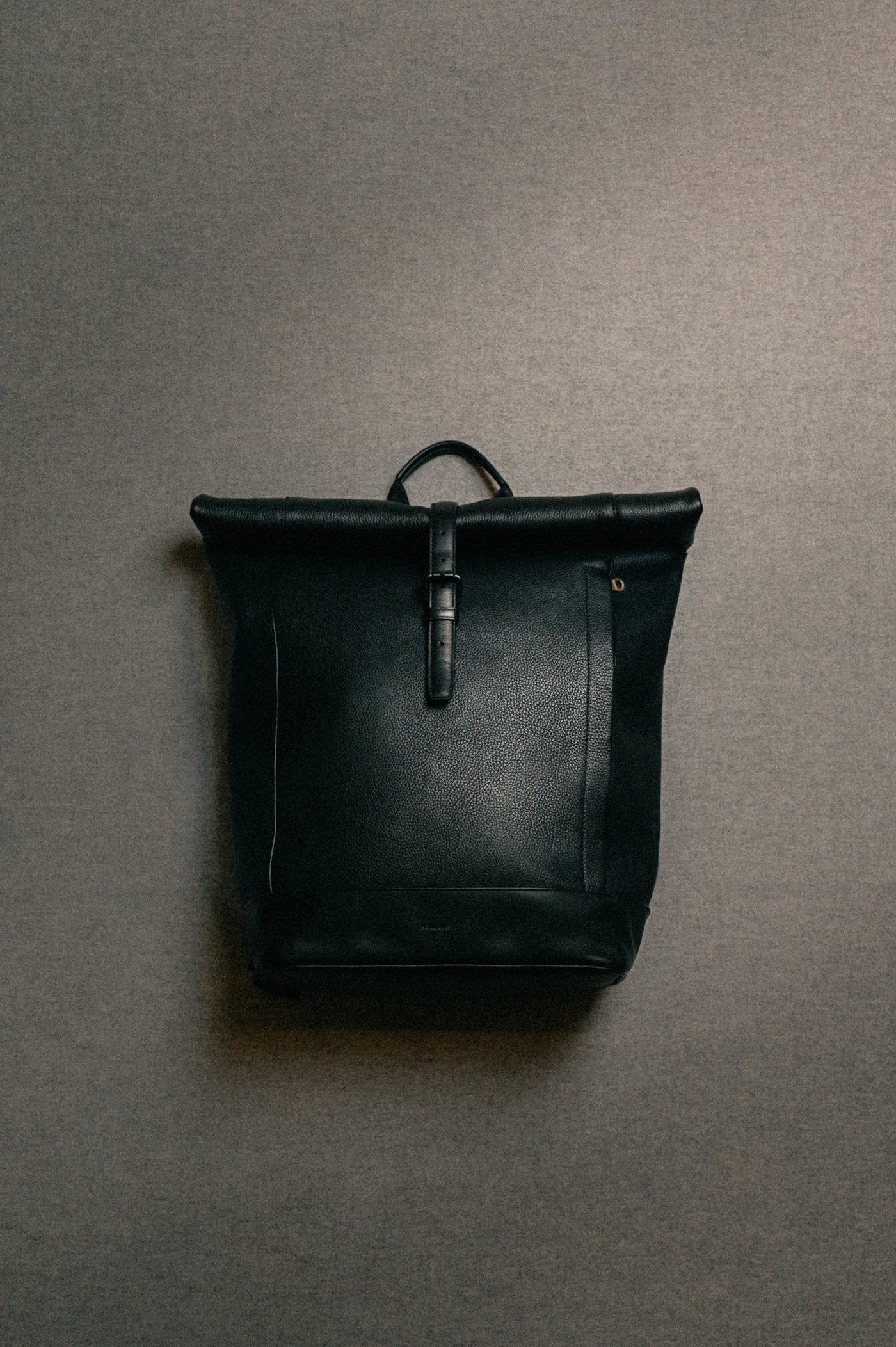 Leather rolltop backpack is in color black (14 of 15)