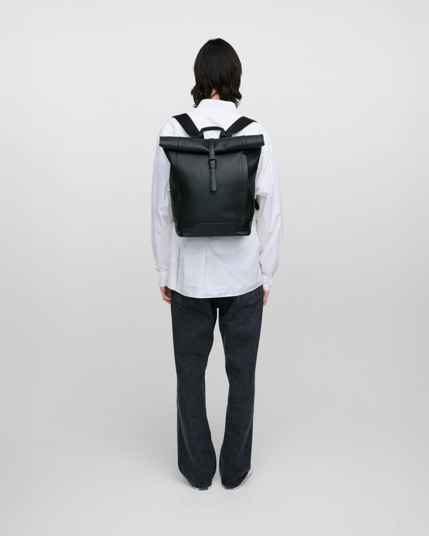 Leather rolltop backpack is in color black (13 of 15)